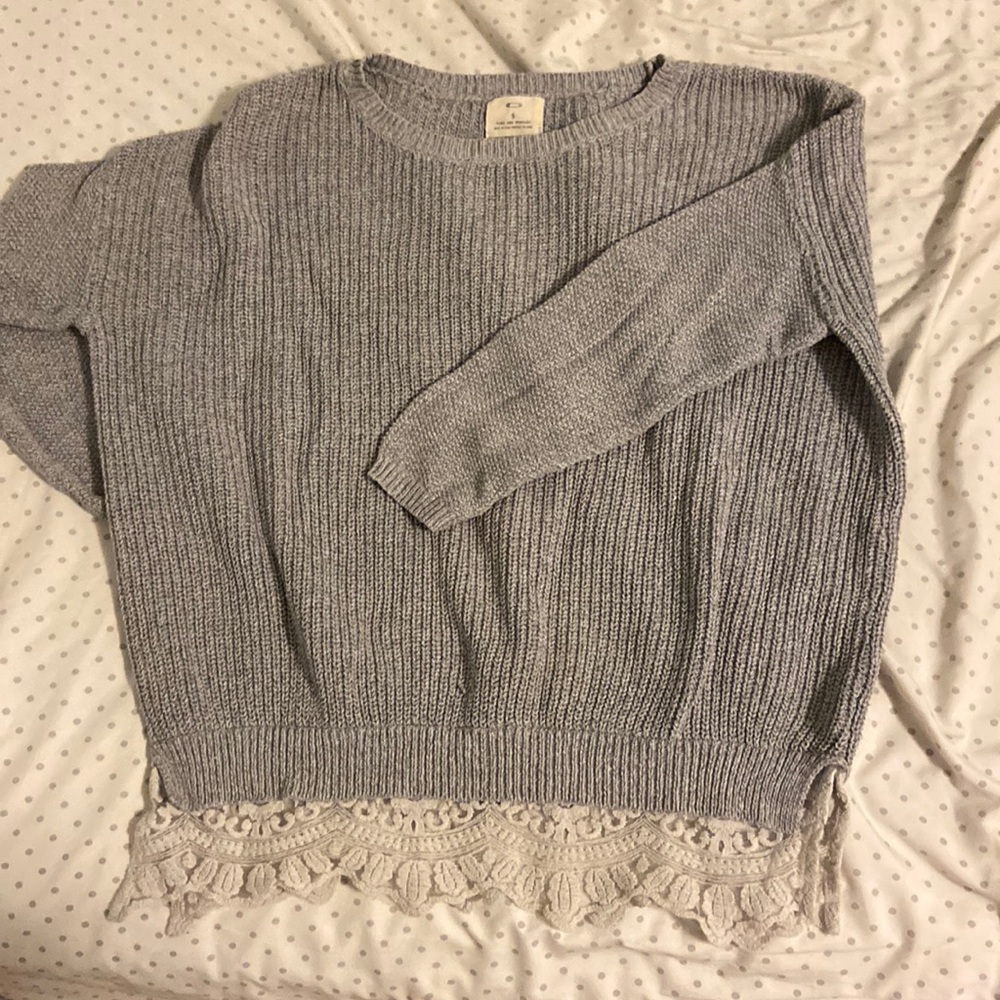 Heather grey knit sweater with lace detailing at the bottom